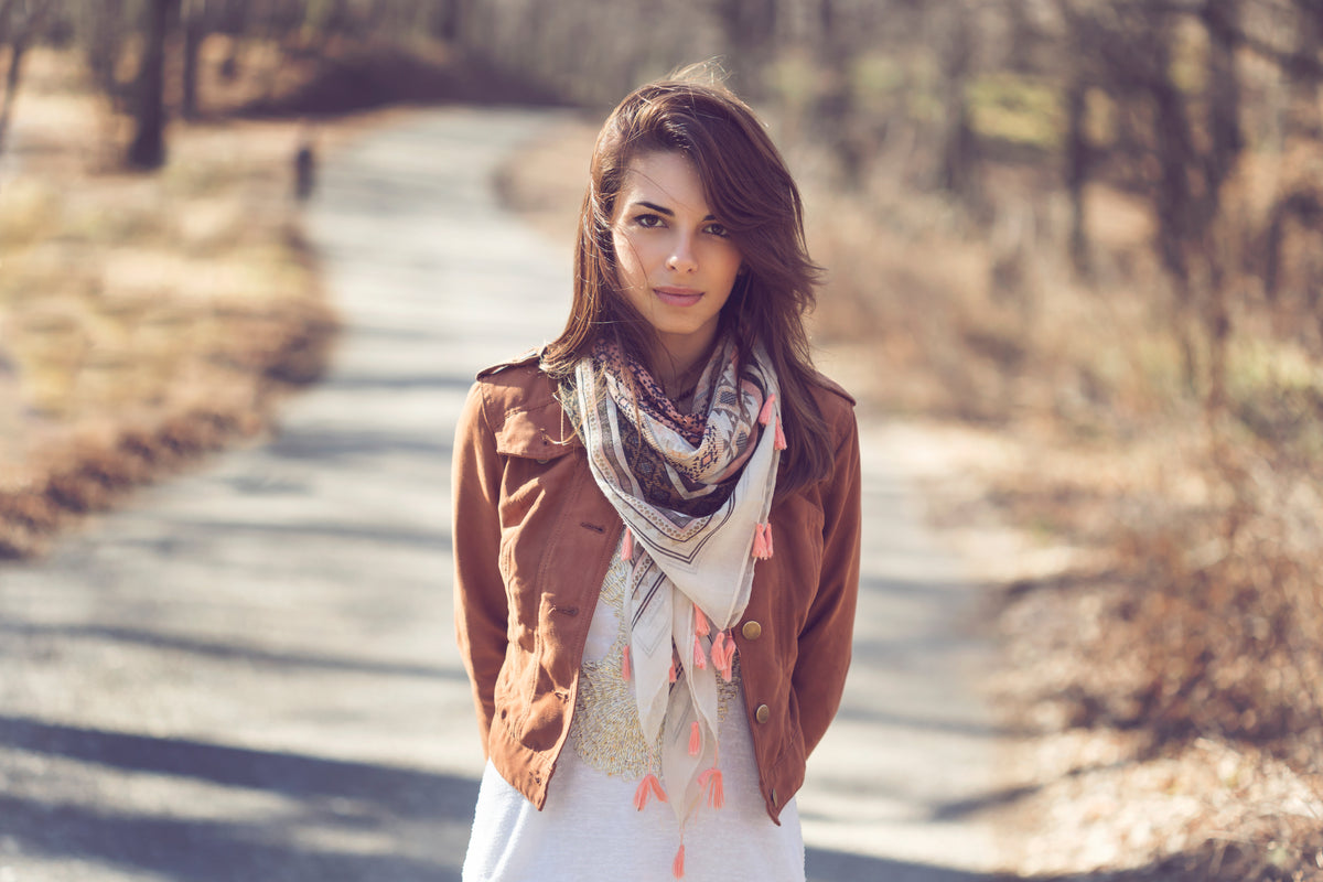 a model wearing a scarf in a chic simple OnPost style with a coquette touch