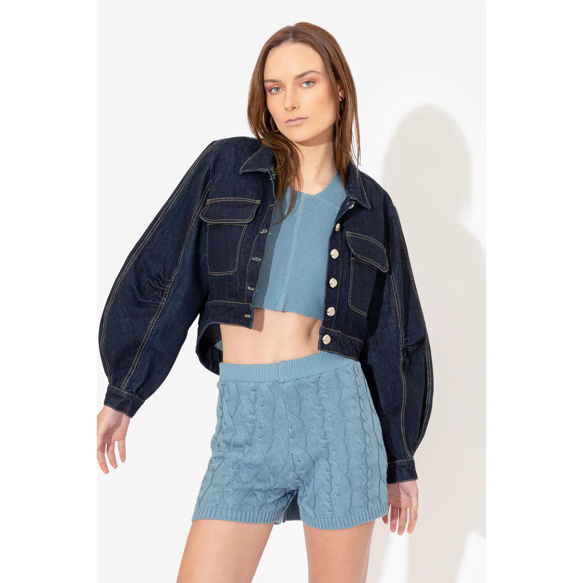 a model showing how to style denim jackets with a clear blue top and short in a OnPost Style