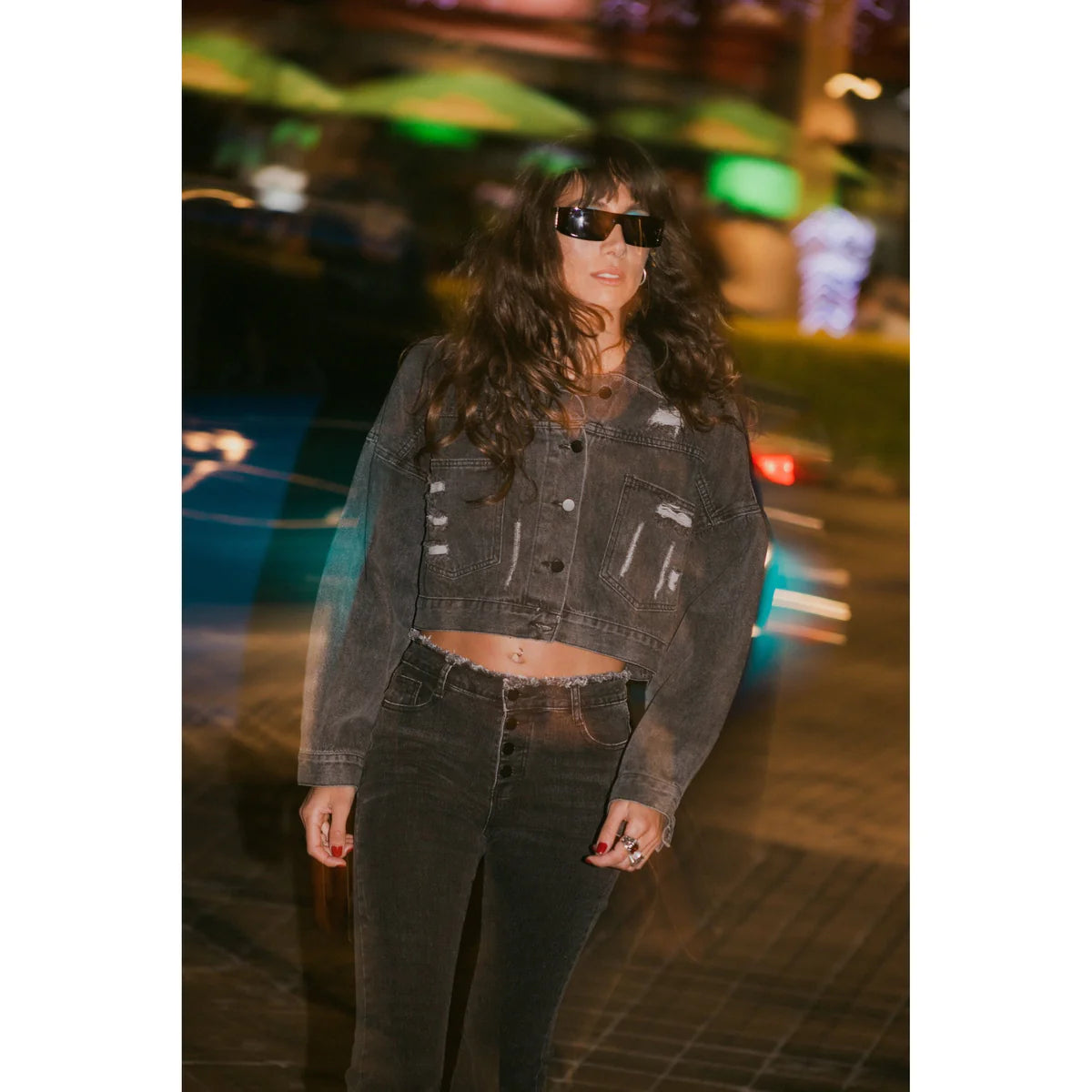 a girl with a black denim jacket in black skinny jeans showing how to style grunge with sunglasses on OnPost