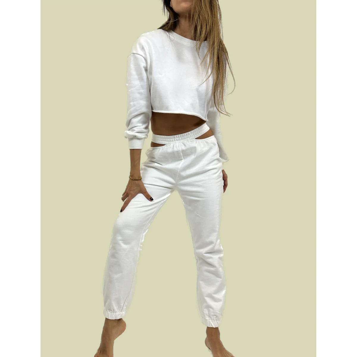 a model showing us what to wear with white joggers in a casual look with a white crop top by OnPost