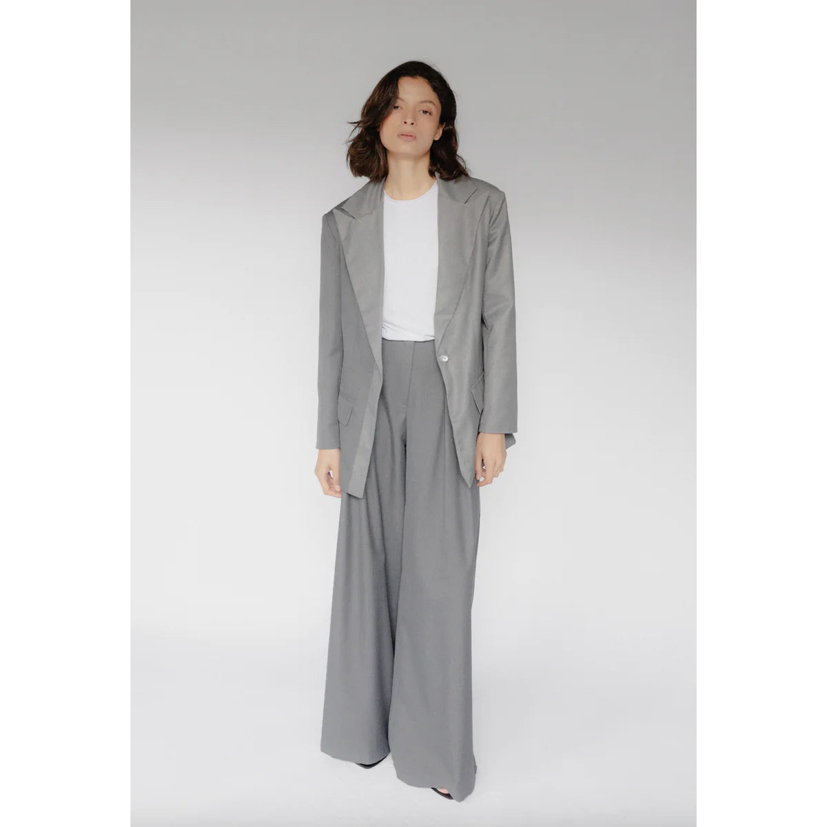 a girl wearing a suit on how to style pants