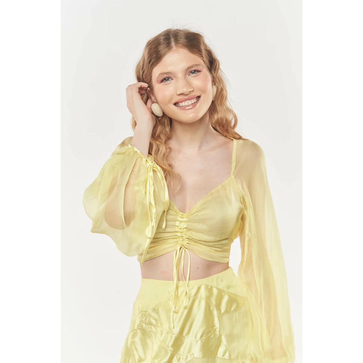 a model smiling showing us how to style yellow in a beautiful dress with OnPost